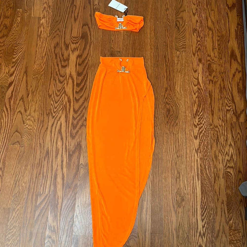 Bikini style top with asymmetrical skirt and metal accessories